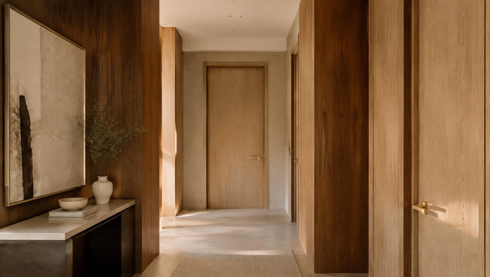 Modern interior with walnut wood panelling and brass door handles